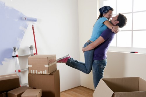 Removal van team preparing for a house move with boxes and trolley